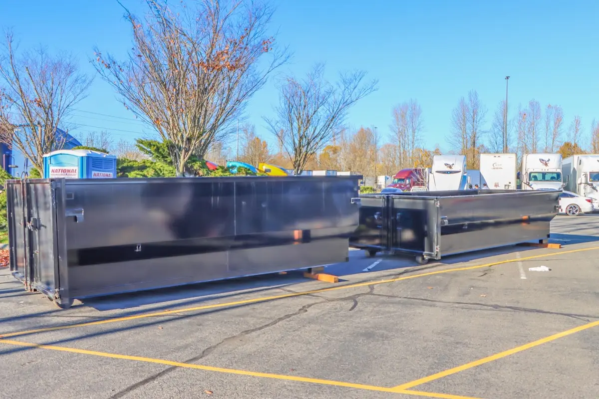 Professional dumpster rental service with roll-off container on residential driveway in Islip